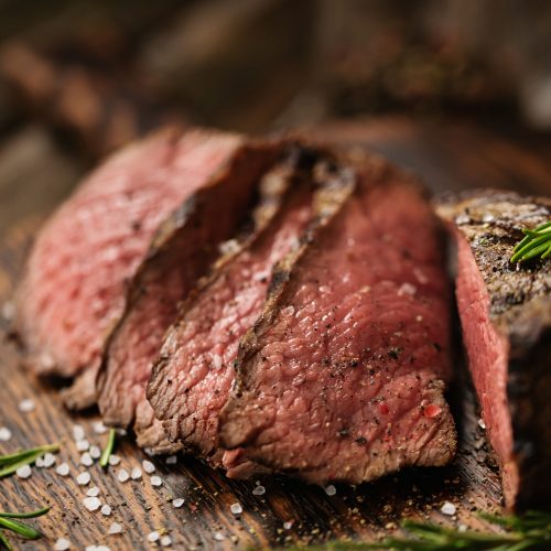 Juicy,Medium,Beef,Rib,Eye,Steak,Slices,On,Wooden,Board