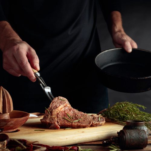 Chef,Prepare,Steak.,Uncooked,Steak,In,Sauce,With,Spices,An